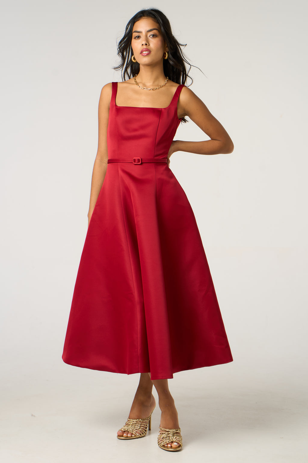 Woman wearing a red dress on a white background