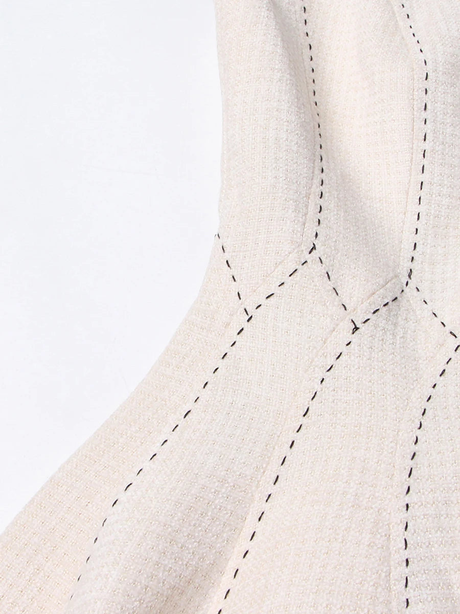 Close-up of a textured fabric with stitching details on a white background