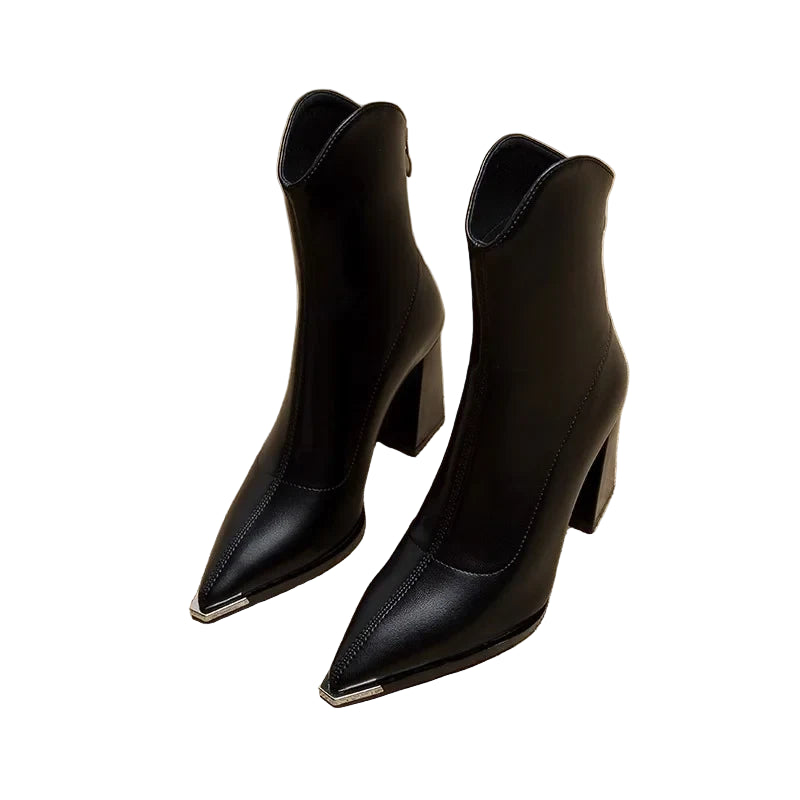 Black high-heeled ankle boots on a textured newspaper background
