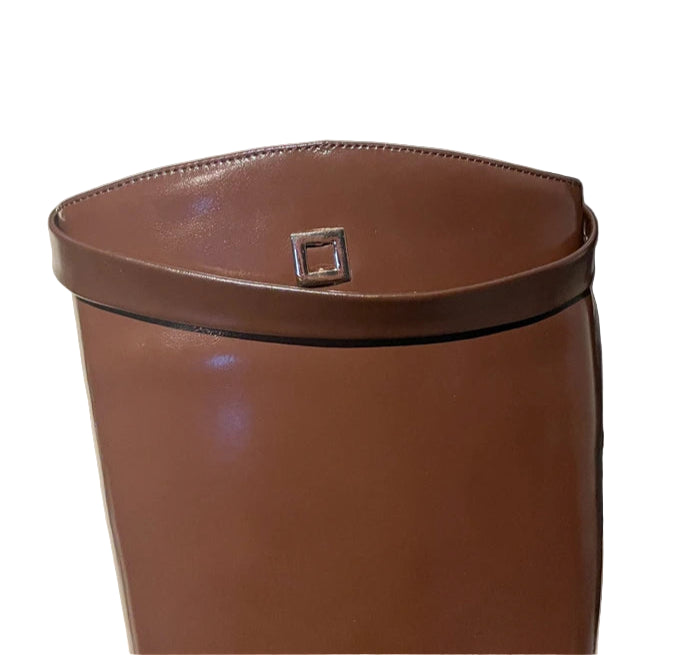 Brown leather bag with a silver buckle on a textured surface