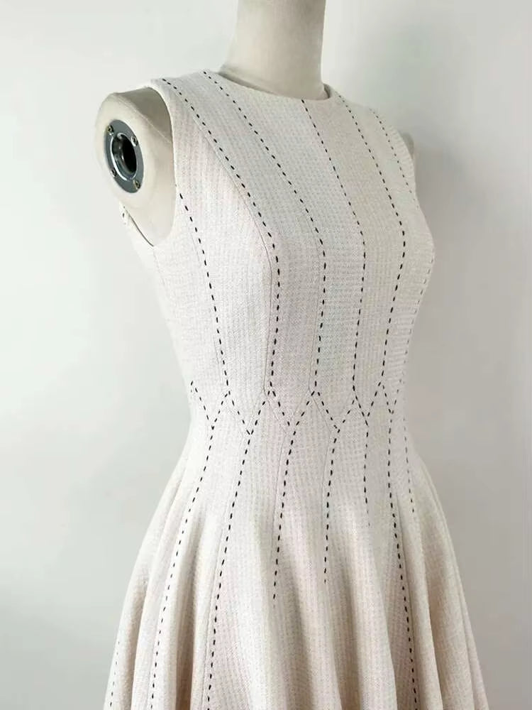 Beige sleeveless dress on a mannequin against a white background