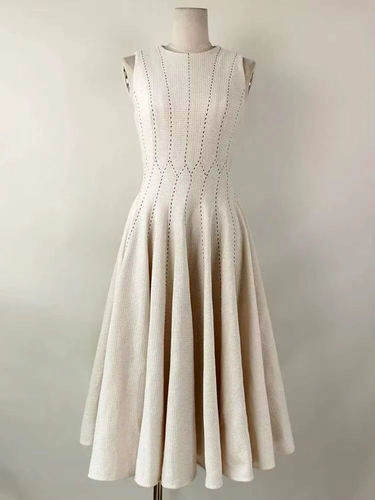 Beige dress on a mannequin against a plain background